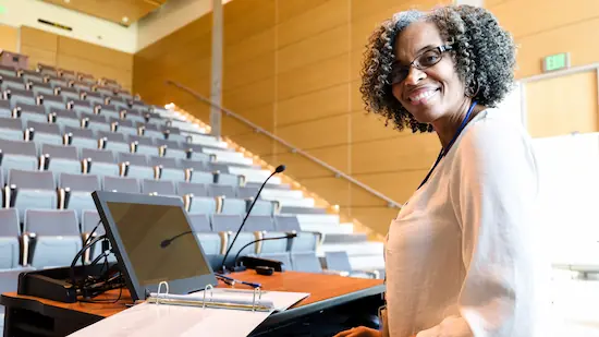 University professor female smiling in the classroom